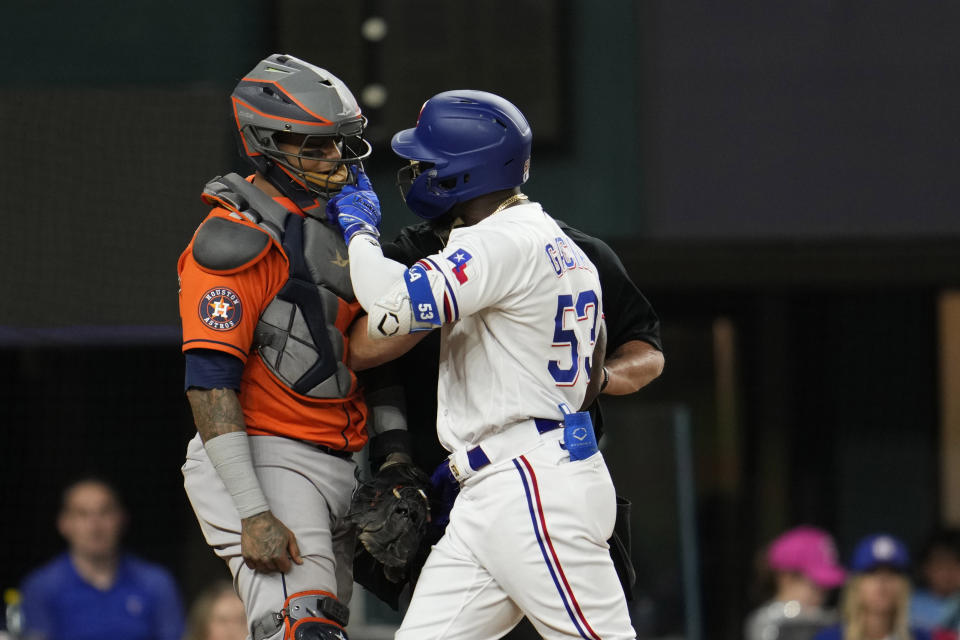Texas Rangers' Adolis Garcia, right, yells at Houston Astros catcher Martin Maldonado after being hit by a pitch during the eighth inning in Game 5 of the baseball American League Championship Series Friday, Oct. 20, 2023, in Arlington, Texas. (AP Photo/Godofredo A. Vásquez)