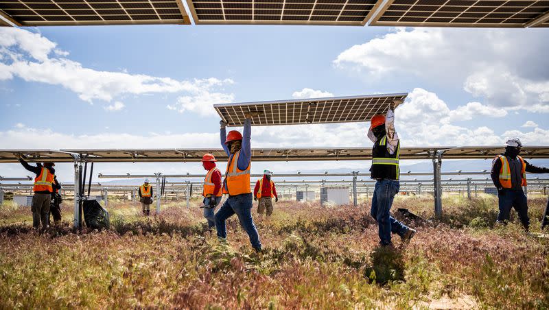 Crews work to install photovoltaic panels on racking at the Appaloosa Solar 1 project near Cedar City on Thursday, June 8, 2023.