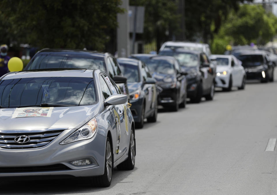 A caravan of union members stop outside the Franco Nursing & Rehabilitation Center to hand out masks to prevent the spread of the new coronavirus and lunches to workers, Monday, July 20, 2020, in Miami. Most facilities, experts and industry leaders told The Associated Press that a statewide mask mandate would help protect staff members, and consequently residents, from the virus. (AP Photo/Wilfredo Lee)