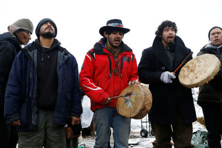 Members of the Cheyenne River Sioux Tribe and others sing as they prepare to evacuate the main opposition camp against the Dakota Access oil pipeline near Cannon Ball, North Dakota, U.S., February 22, 2017. REUTERS/Terray Sylvester