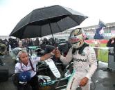 Britain Formula One - F1 - British Grand Prix 2016 - Silverstone, England - 10/7/16 Mercedes' Lewis Hamilton sheilds from the rain before the race REUTERS/Matthew Childs Livepic