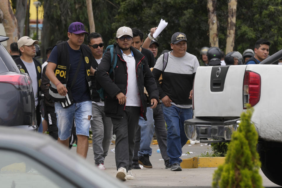 Police detain anti-government protesters at the San Marcos University in Lima, Peru, Saturday, Jan. 21, 2023. Police evicted from the university grounds protesters who arrived from Andean regions seeking the resignation of President Dina Boluarte, the release from prison of ousted President Pedro Castillo and immediate elections. (AP Photo/Martin Mejia)