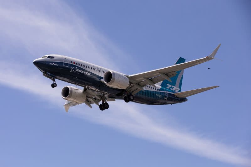 A Boeing 737 MAX airplane lands after a test flight at Boeing Field in Seattle