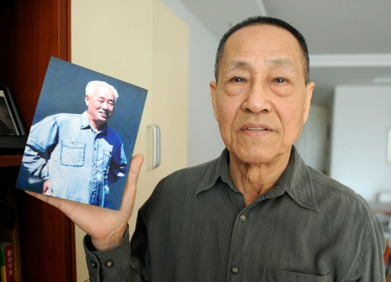 Bao Tong, a former Chinese government official jailed for opposing the 1989 Tiananmen Square crackdown, holds up a photo of his former boss Zhao Ziyang during an interview at his home in Beijing on February 22, 2011