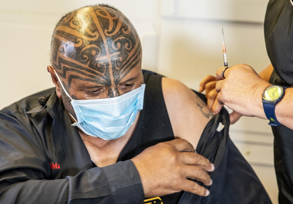 Rangi McLean receives his COVID-19 vaccine at the Manurewa Marae vaccination center in south Auckland, New Zealand, April 8, 2021. Some wealthy nations that were most praised last year for controlling the coronavirus are now lagging far behind in getting their people vaccinated — and some, especially in Asia, are seeing COVID-19 cases grow. (Michael Craig/New Zealand Herald via AP)