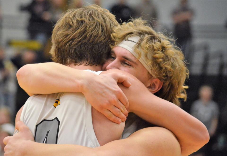 Hamilton's Thano Klett (right) hugs Justin McIllwain after winning districts.