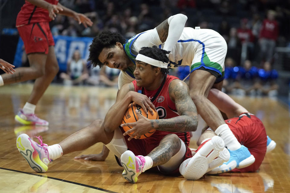 Southeast Missouri State's Phillip Russell grabs a loose ball against Texas A&M Corpus Christi's Simeon Fryer during the first half of a First Four college basketball game in the NCAA men's basketball tournament, Tuesday, March 14, 2023, in Dayton, Ohio. (AP Photo/Darron Cummings)
