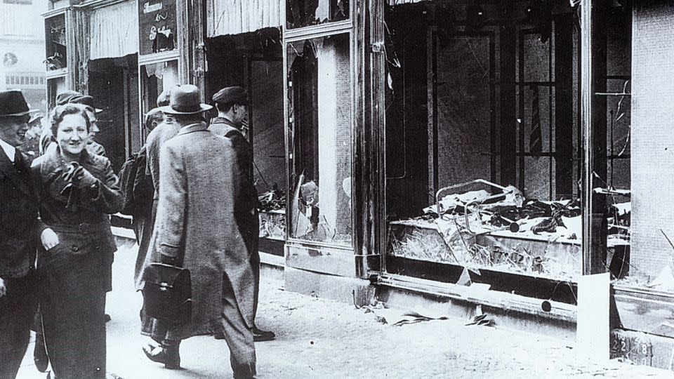 Pedestrians glance at the broken windows of a Jewish owned shop in Berlin after the attacks of Kristallnacht, November 1938. - Universal Images Group Editorial/Getty Images