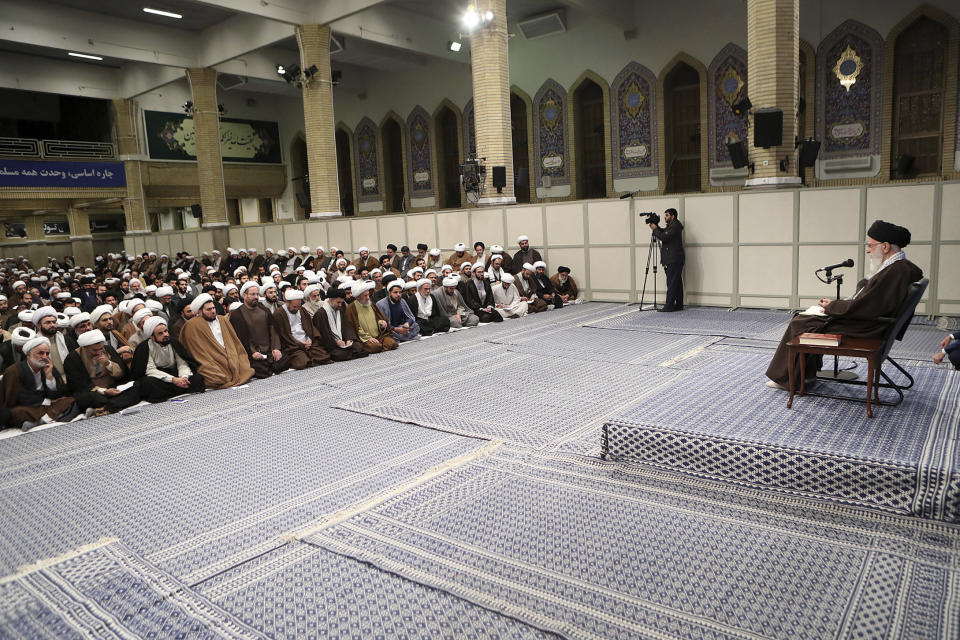 In this photo released by the official website of the office of the Iranian supreme leader, Supreme Leader Ayatollah Ali Khamenei, right, talks to clerics in his Islamic thoughts class in Tehran, Iran, Sunday, Nov. 17, 2019. Iran's supreme leader supported the government's decision to increase gasoline prices and says that those setting fire to public property during protests against the hikes are "bandits" backed by the enemies of Iran. (Office of the Iranian Supreme Leader via AP)