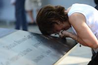 Geraldine Davie of Pelham, New York, cries after viewing name of her 23-year-old daughter Amy O'Doherty who was killed in the 9/11 World Trade Center attacks, during a ceremony marking the 12th anniversary of the event in New York September 11, 2013. (REUTERS/David Handschuh)