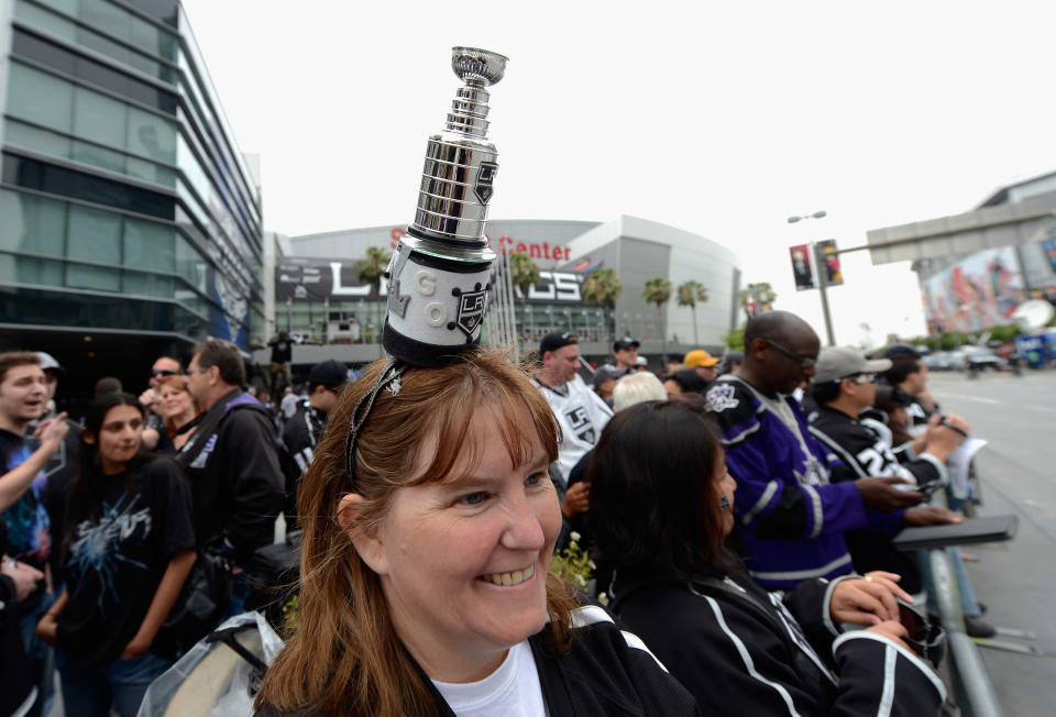 LOS ANGELES, CA - JUNE 14: Trudy De Fino, from Mission Hills, California, with a miniature Stanley Cup trophy on her head, waits for the start of the Stanley Cup victory parade on June 14, 2012 in Los Angeles, California. The Kings are celebrating thier first NHL Championship in the team's 45-year-old franchise history. (Photo by Kevork Djansezian/Getty Images)