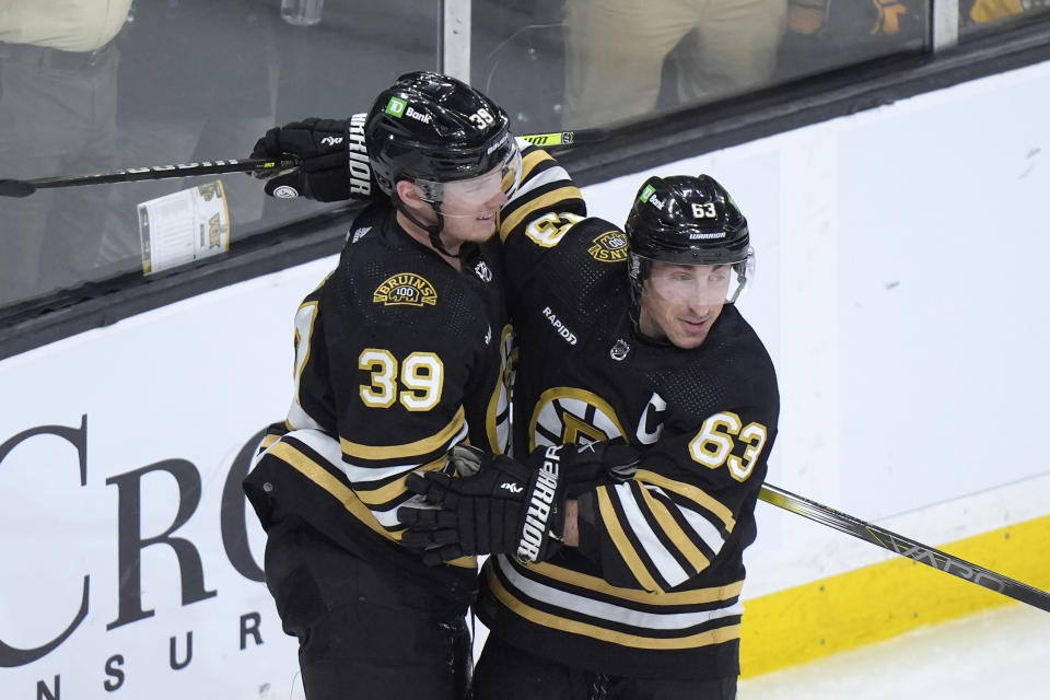 Boston Bruins center Morgan Geekie (39) celebrates with left wing Brad Marchand (63) after scoring in the second period of an NHL hockey game against the Vegas Golden Knights, Thursday, Feb. 29, 2024, in Boston. (AP Photo/Steven Senne)