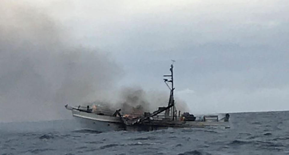 A boat on fire off the Queensland coast.