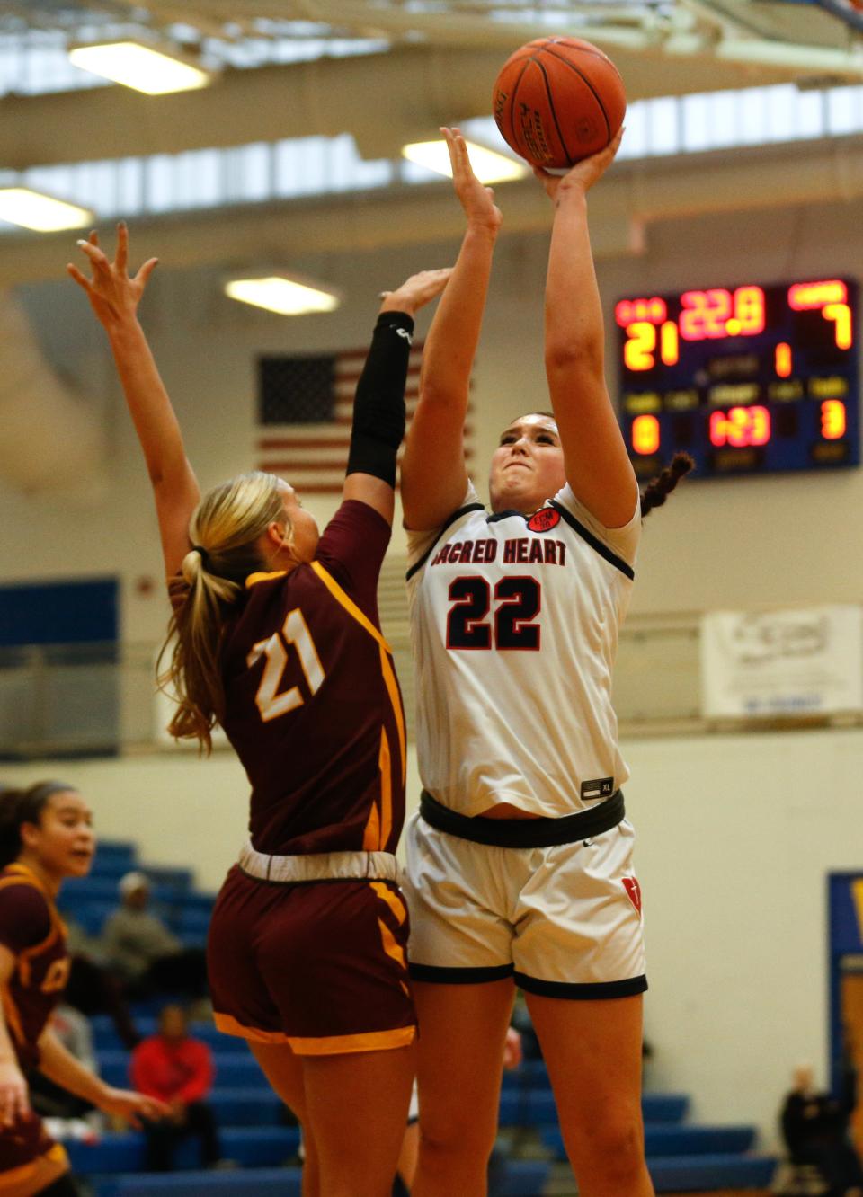 Sacred Heart’s Angelina Pelayo tries to make a shot against Cooper’s Bella Deere in an LIT semifinal Saturday.