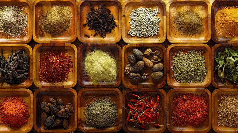 various spices in wooden trays