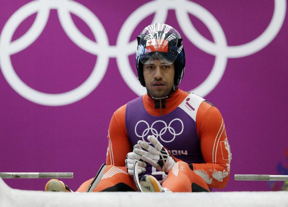 Bruno Banani of Tonga prepares to start a run during a training session for the men's singles luge at the 2014 Winter Olympics, Thursday, Feb. 6, 2014, in Krasnaya Polyana, Russia. (AP Photo/Dita Alangkara)