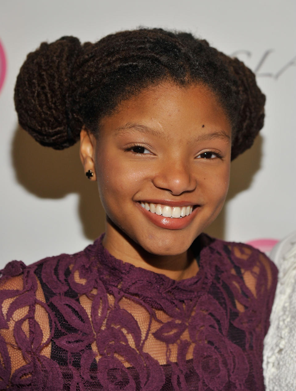 closeup of her with her braids in two buns