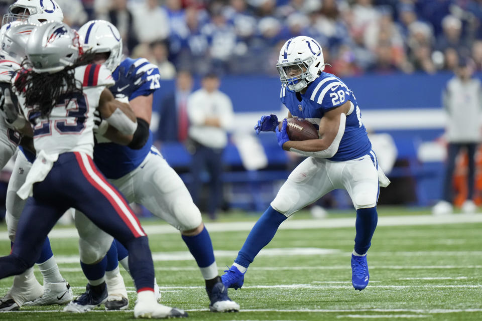 Indianapolis Colts running back Jonathan Taylor (28) runs with the ball during the first half of an NFL football game against the New England Patriots Saturday, Dec. 18, 2021, in Indianapolis. (AP Photo/AJ Mast)