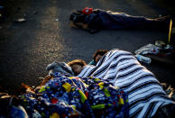 A migrant family, part of a caravan of thousands traveling from Central America en route to the United States, sleeps at a makeshift camp at a gas station where the migrants wait for buses in Navojoa, Mexico November 16, 2018. REUTERS/Kim Kyung-Hoon