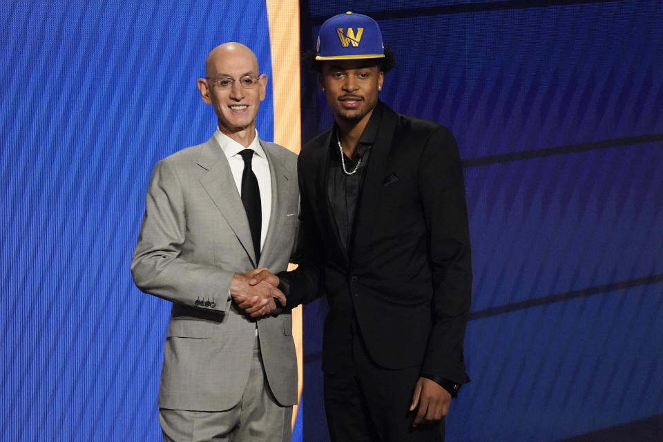 Moses Moody poses for a photo with NBA Commissioner Adam Silver after being selected 14th overall by the Golden State Warriors during the NBA basketball draft, Thursday, July 29, 2021, in New York. - Credit: AP