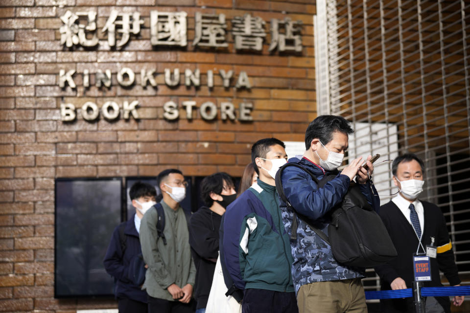 Customers queue up to buy Japanese writer Haruki Murakami's new novel "The City and Its Uncertain Walls" on the first day for sale at Kinokuniya bookstore in Shinjuku district early Thursday, April 13, 2023, in Tokyo. (AP Photo/Eugene Hoshiko)