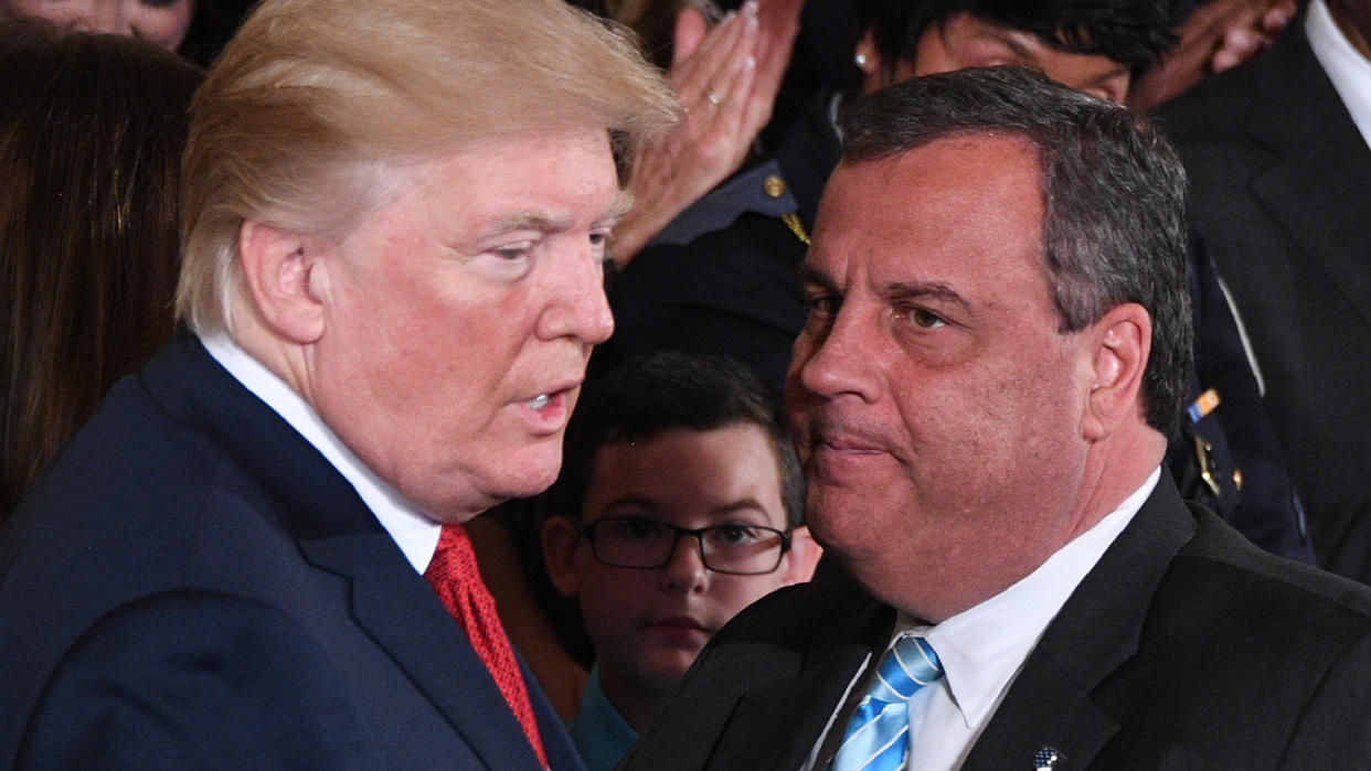 US President Donald Trump (L) speaks with Governor Chris Christie (R-NJ) after he delivered remarks on combatting drug demand and the opioid crisis on October 26, 2017 in the East Room of the White House in Washington, DC. (Jim Watson/AFP via Getty Images)