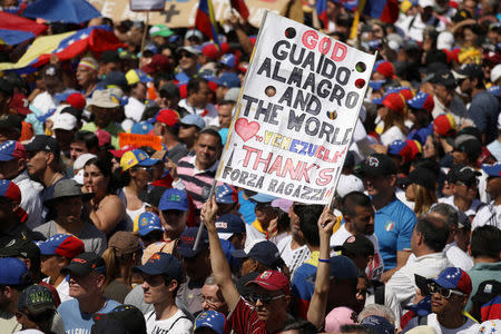 A supporter holds a placard as he takes part in a rally against Venezuelan President Nicolas Maduro's government in Caracas, Venezuela February 2, 2019. REUTERS/Andres Martinez Casares