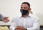 Houston Police officer Felipe Gallegos tears up as Rusty Hardin speaks during a press conference at Hilton Americas, Tuesday, Jan. 26, 2021, in Houston. Gallegos has been charged with murder and is among additional officers who have been indicted as part of an ongoing investigation into a Houston Police Department narcotics unit following a deadly 2019 drug raid, prosecutors announced Monday. (Karen Warren/Houston Chronicle via AP)