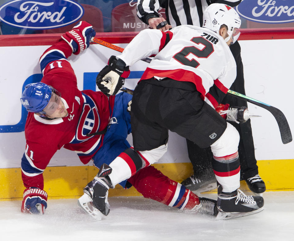 Montreal Canadiens right wing Brendan Gallagher (11) is checked by Ottawa Senators defenseman Artem Zub (2) during the second period of an NHL hockey game Tuesday, March 2, 2021, in Montreal. (Ryan Remiorz/The Canadian Press via AP)