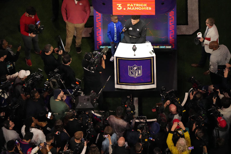 Kansas City Chiefs quarterback Patrick Mahomes, center, is interviewed during the NFL football Super Bowl 58 opening night Monday, Feb. 5, 2024, in Las Vegas. The San Francisco 49ers will play the Kansas City Chiefs in Super Bowl 58 Sunday. (AP Photo/David J. Phillip)