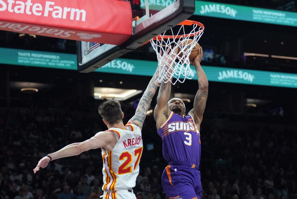 Phoenix Suns guard Bradley Beal (3) dunks over Atlanta Hawks guard Vit Krejci (27) during the first half at Footprint Center.