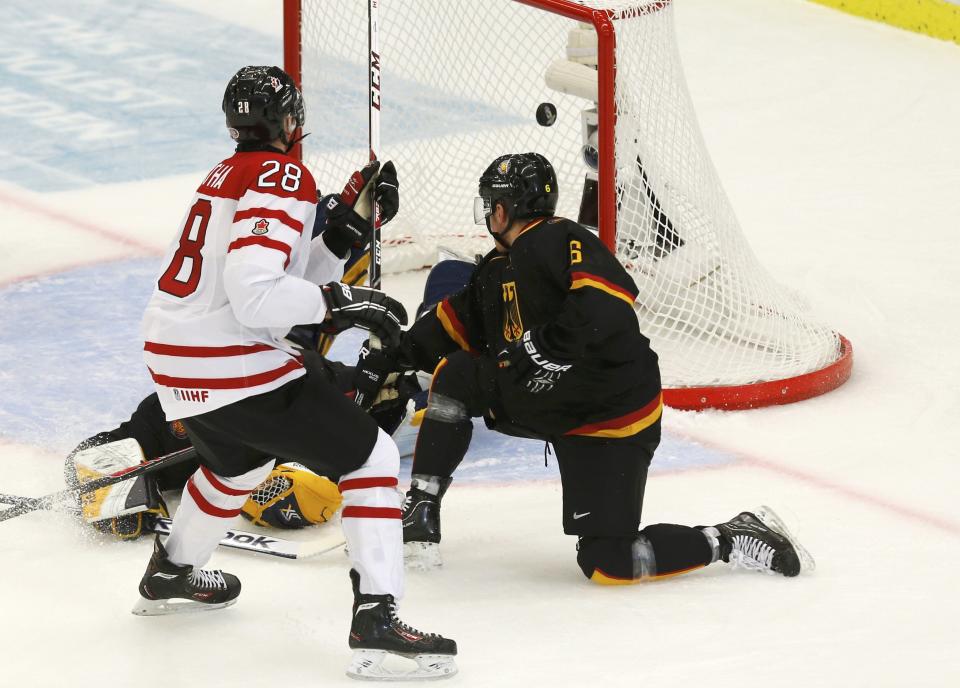 Canada's Mantha scores on Germany's goalie Cupper as Germany's Tuomie tries to defend during the first period of their IIHF World Junior Championship ice hockey game in Malmo