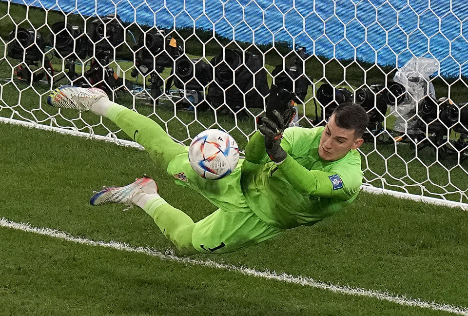 Croatia's goalkeeper Dominik Livakovic stops a penalty kick from Brazil's Rodrygo during the penalty shootout in the World Cup quarterfinal soccer match between Croatia and Brazil, at the Education City Stadium in Al Rayyan, Qatar, Friday, Dec. 9, 2022. (AP Photo/Pavel Golovkin)