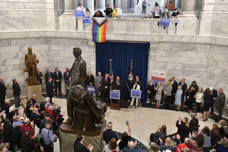 FILE - Supporters of Senate bill 150, known as the Transgender Health Bill gather in the Rotunda of the Kentucky State Capitol as protesters look on from the balcony on March 29, 2023, in Frankfort, Ky. A new dispute has erupted in June over Kentucky's sweeping transgender law, revolving around one word in a section banning sex education topics — including sexual orientation — from discussion in classrooms. (AP Photo/Timothy D. Easley, File)