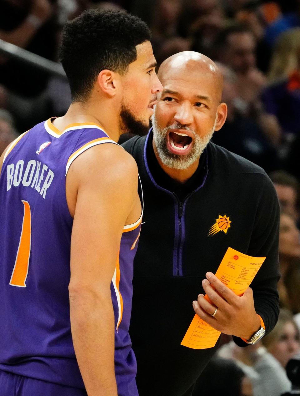 Phoenix Suns head coach Monty Williams talks to guard Devin Booker (1) against the Minnesota Timberwolves in the second half at Footprint Center in Phoenix on March 29, 2023.