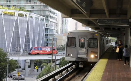 Miami's Metrorail train makes a stop as a Peoplemover car moves at left in downtown Miami, Florida November 5, 2015. REUTERS/Joe Skipper