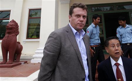 Russian tycoon Sergei Polonsky (C) and his lawyer (wearing tie) speak to the media at the Appeal Court in central Phnom Penh January 13, 2014. REUTERS/Samrang Pring