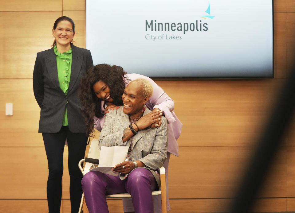 Minneapolis City Council members, from right, Linea Palmisan, LaTrisha Vetaw and Council President Andrea Jenkins shared a light moment before a press conference announcing approval of a sweeping plan to reform policing that aims to reverse years of systemic racial bias Friday, March 31, 2023 at the Minneapolis Public Service Building in Minneapolis. The Minneapolis City Council on Friday approved an agreement with the state to revamp policing, nearly three years after a city officer killed George Floyd. (David Joles/Star Tribune via AP)