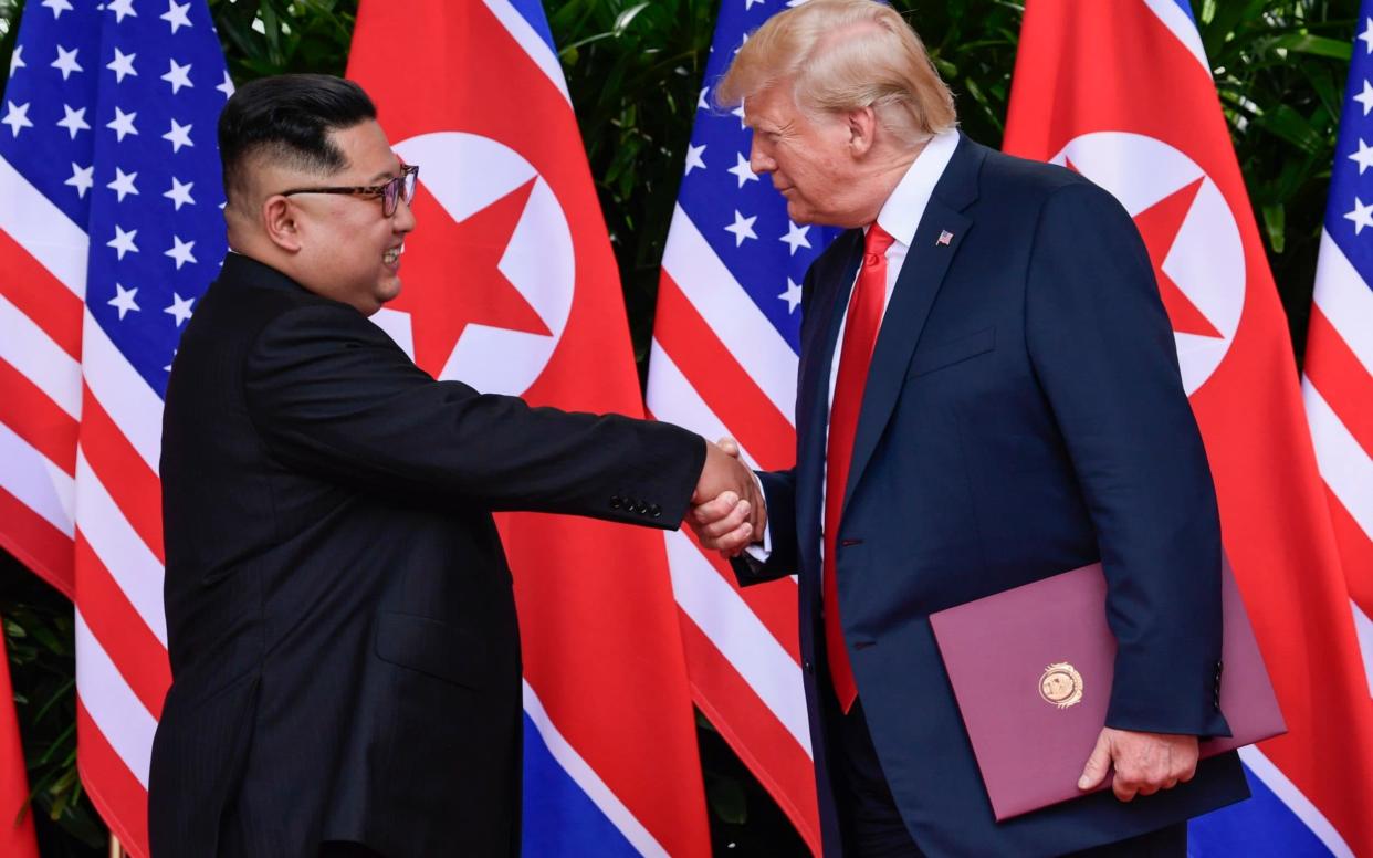 Kim Jong-un and Donald Trump at their first meeting in Singapore last June - AP Pool