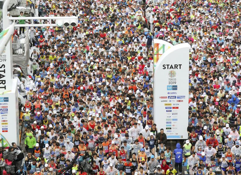 Runners fill the street at the start of the Tokyo Marathon in Tokyo, Japan