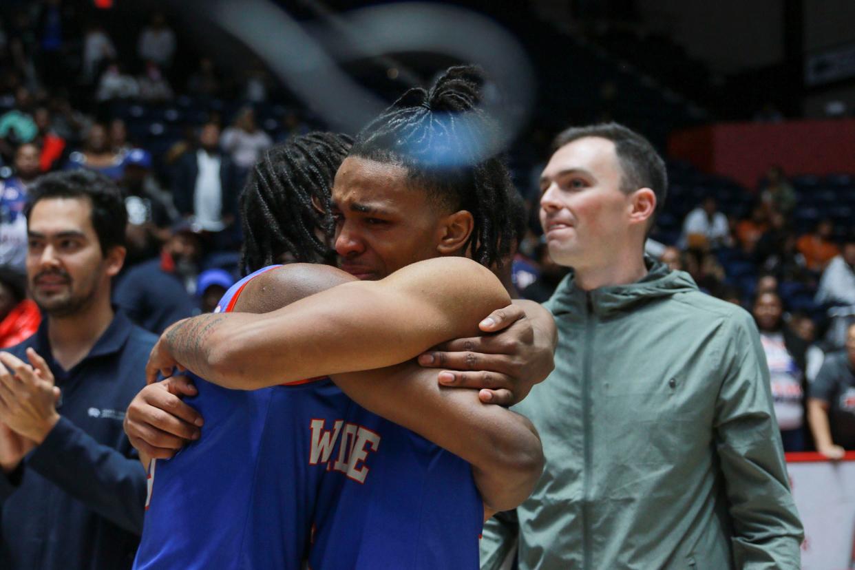 Westside forward Jalexs Ewing (0) hugs point guard 	AuMauri Tillman (5) after the Westside and Providence Christian Academy AA boys basketball state championship game at the Macon Coliseum in Macon, Ga., on Thursday, March 9, 2023. Westside won in overtime 89-81 and are state champions for the second year in a row. 