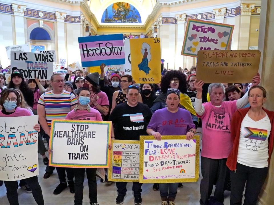 Trans-rights activists protest outside the House chamber at the Oklahoma Capitol before the State of the State address, Feb. 6, 2023, in Oklahoma City.