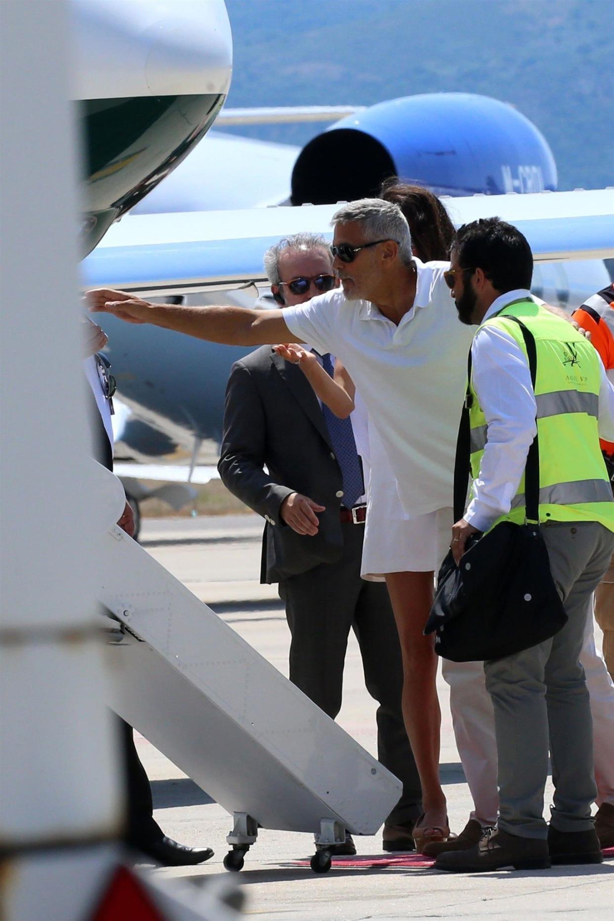 George Clooney was back on his feet just days after being hospitalized from a motorcycle accident. The actor was seen being helped onto his private jet by his wife Amal and airport staff in Sardinia on July 12, 2018.