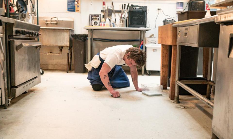 Jeremy Allen White as Carmen ‘Carmy’ Berzatto scrubs the kitchen floor in a scene from The Bear