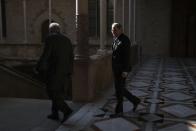 Catalan regional President Quim Torra, right, walks at the Palace of the Generalitat prior to a meeting with Spanish Prime Minister Pedro Sanchez, in Barcelona, Thursday, Feb. 6, 2020. (AP Photo/Emilio Morenatti)