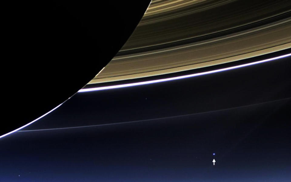In this rare image taken by the wide angle camera of NASA's Cassini spacecraft on July 19, 2013, Earth (denoted with an arrow) is pictured with Saturn's rings in the foreground.