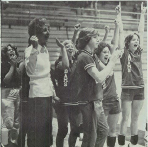 Rian Meyers, a boy on South Bend Adams girls volleyball team cheers from the sidelines. He was one of three boys on the team in 1976.