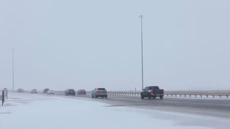 Cars move along a snow-covered road in Denver, U.S., January 22, 2019 in this video grab obtained from social media video by Reuters January 28, 2019. Denver International Airport/via REUTERS