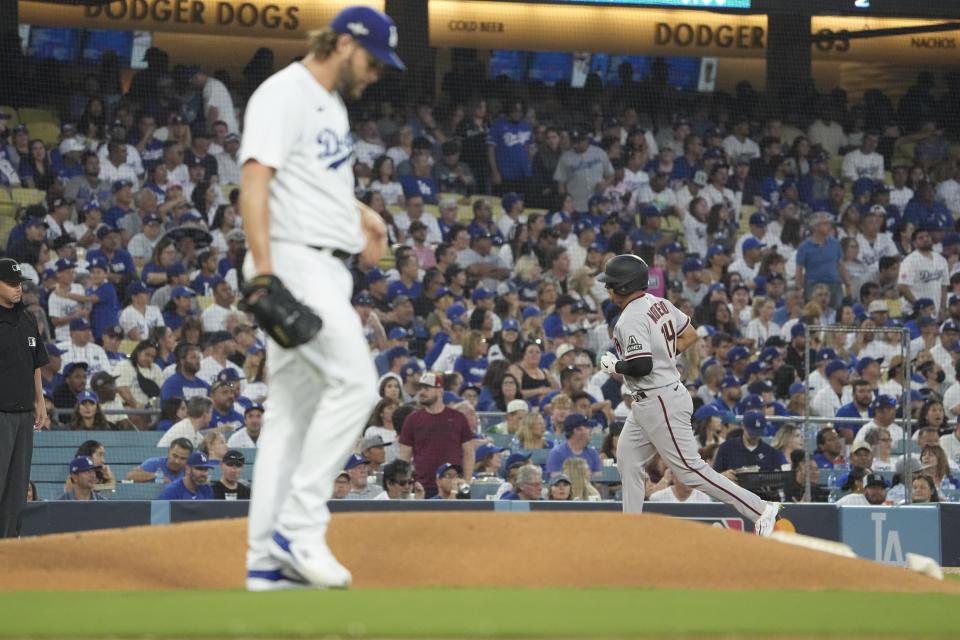 Arizona Diamondbacks' Gabriel Moreno, right, passes Los Angeles Dodgers starting pitcher Clayton Kershaw as he rounds the bases after hitting a three-run home run during the first inning in Game 1 of a baseball NL Division Series Saturday, Oct. 7, 2023, in Los Angeles. (AP Photo/Mark J. Terrill)