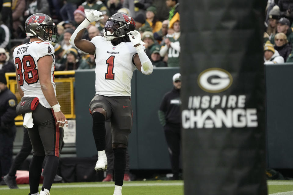 Tampa Bay Buccaneers running back Rachaad White (1) celebrates after catching a 26-yard touchdown pass during the second half of an NFL football game against the Green Bay Packers, Sunday, Dec. 17, 2023, in Green Bay, Wis. (AP Photo/Morry Gash)